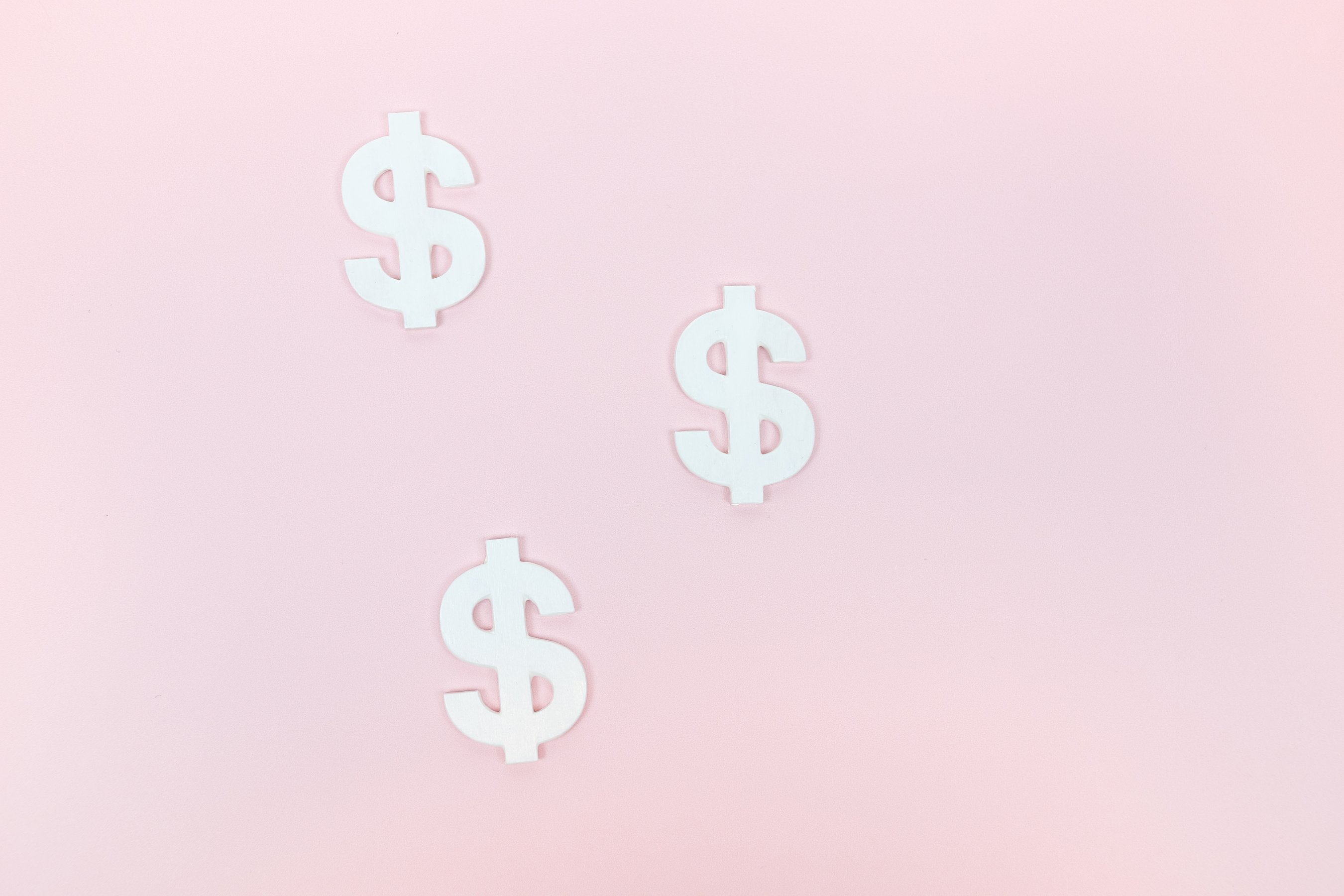 Dollar Signs on a Pink Background